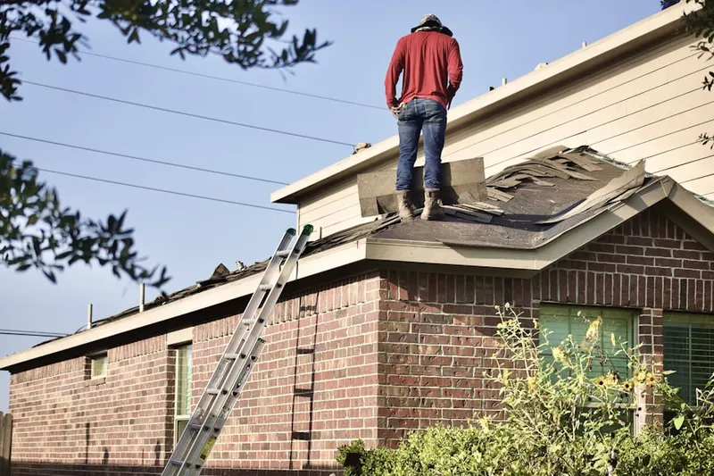 Professional roofer working on a residential roof in Biltmore Shores